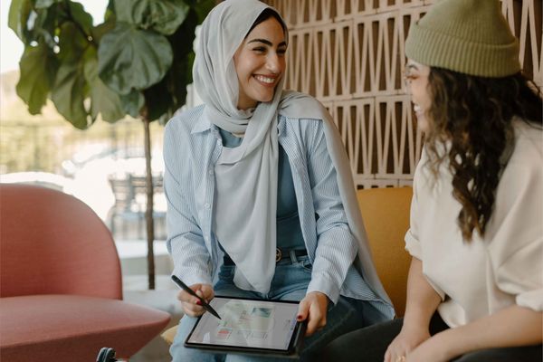 two women facing each other collaborating at work